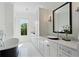 Bathroom with dual sink vanity, sleek black framed mirror, modern lighting, and soaking tub next to the window at 1285 Stuart Rdg, Johns Creek, GA 30022