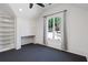Bedroom with built-in shelving, a built-in desk, and a large window offering picturesque backyard views at 1285 Stuart Rdg, Johns Creek, GA 30022