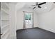 Bedroom offers ample closet space, a ceiling fan, and a large window providing abundant natural light at 1285 Stuart Rdg, Johns Creek, GA 30022