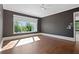 Spacious bedroom with hardwood floors, recessed lighting, a ceiling fan, and a large window for natural light at 1285 Stuart Rdg, Johns Creek, GA 30022