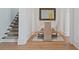 Cozy dining area with hardwood flooring and adjacent to a staircase at 1285 Stuart Rdg, Johns Creek, GA 30022