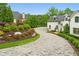 Elegant driveway with landscaped gardens leading to a modern home at 1285 Stuart Rdg, Johns Creek, GA 30022