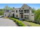 Beautiful exterior view of the stunning white home with a circular driveway at 1285 Stuart Rdg, Johns Creek, GA 30022