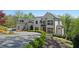 Beautiful home exterior with lush landscaping and a circular driveway at 1285 Stuart Rdg, Johns Creek, GA 30022