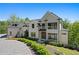 Stunning exterior of a modern home with manicured landscaping and a paved driveway at 1285 Stuart Rdg, Johns Creek, GA 30022