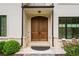 Close up of the beautiful wood double front door with black hardware at 1285 Stuart Rdg, Johns Creek, GA 30022