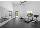 Spacious home gym with mirrored wall and a variety of fitness equipment at 1285 Stuart Rdg, Johns Creek, GA 30022