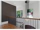 Hallway boasts hardwood floors, black railings, recessed lighting, and backyard views through multiple windows at 1285 Stuart Rdg, Johns Creek, GA 30022