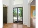 Hallway with hardwood floors and doors leading to a balcony with views at 1285 Stuart Rdg, Johns Creek, GA 30022