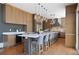 Gourmet kitchen featuring a large center island with seating, custom cabinets, and pendant lighting at 1285 Stuart Rdg, Johns Creek, GA 30022