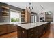 Open kitchen with island, floating shelves, custom cabinetry, and sliding glass doors to backyard deck at 1285 Stuart Rdg, Johns Creek, GA 30022