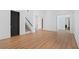 Open-concept living room showcasing hardwood flooring and access to staircase at 1285 Stuart Rdg, Johns Creek, GA 30022