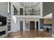 Expansive living room with hardwood floors, fireplace, and staircase to the second floor at 1285 Stuart Rdg, Johns Creek, GA 30022