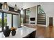 Spacious living room featuring an open floorplan, fireplace, floating shelves, and backyard view at 1285 Stuart Rdg, Johns Creek, GA 30022