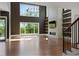Bright living room with hardwood floors, floor-to-ceiling windows, and a modern fireplace at 1285 Stuart Rdg, Johns Creek, GA 30022