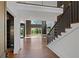 Open-concept living area with high ceilings, large windows, and a staircase with iron railings at 1285 Stuart Rdg, Johns Creek, GA 30022