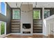 Modern living room with floor to ceiling windows, fireplace and custom built-in shelving at 1285 Stuart Rdg, Johns Creek, GA 30022