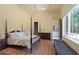 Large main bedroom featuring a four poster bed, natural light, and ensuite access at 1285 Stuart Rdg, Johns Creek, GA 30022