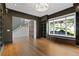Study featuring custom shelving, a large window, and hardwood flooring at 1285 Stuart Rdg, Johns Creek, GA 30022
