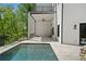 A luxurious covered patio overlooking a private pool and lush landscape, enhancing outdoor living at 1285 Stuart Rdg, Johns Creek, GA 30022