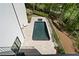 Modern home showcasing a private backyard pool with clean, neutral-colored tiling, surrounded by lush greenery and fencing at 1285 Stuart Rdg, Johns Creek, GA 30022