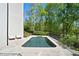 Luxury home featuring a private pool area, perfectly integrated into a lush, landscaped backyard at 1285 Stuart Rdg, Johns Creek, GA 30022