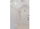 Elegant bathroom shower with multiple fixtures, a bench, and marble-look tile at 1285 Stuart Rdg, Johns Creek, GA 30022