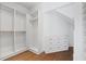 Spacious walk-in closet with custom built-in shelving, drawers, and hardwood flooring at 1285 Stuart Rdg, Johns Creek, GA 30022