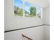 Large window showing a view of the landscaped front yard and neighborhood at 1285 Stuart Rdg, Johns Creek, GA 30022