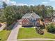Aerial view of the brick home with a long driveway and an expansive, well-manicured front lawn at 1829 Alcovy Shoals Blf, Lawrenceville, GA 30045