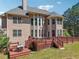 Two-story home featuring a spacious deck and backyard with lush green grass, perfect for outdoor enjoyment at 1829 Alcovy Shoals Blf, Lawrenceville, GA 30045