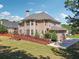 Exterior view of the backyard with a wooden deck, mature trees, and well-maintained lawn at 1829 Alcovy Shoals Blf, Lawrenceville, GA 30045