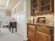 Convenient bar area featuring wooden cabinets, granite countertop, and glass storage for beverages at 1829 Alcovy Shoals Blf, Lawrenceville, GA 30045