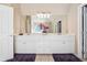Bathroom with a dual sink vanity, white cabinets, and a large mirror at 1829 Alcovy Shoals Blf, Lawrenceville, GA 30045