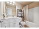 Well-lit bathroom with white cabinets and a shower with bathtub at 1829 Alcovy Shoals Blf, Lawrenceville, GA 30045
