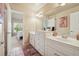 Well-lit bathroom with dual sinks and white vanity at 1829 Alcovy Shoals Blf, Lawrenceville, GA 30045