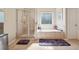 Bathroom features a glass shower, soaking tub, and neutral tile at 1829 Alcovy Shoals Blf, Lawrenceville, GA 30045