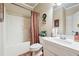 Cozy bathroom with white vanity and shower with bathtub at 1829 Alcovy Shoals Blf, Lawrenceville, GA 30045