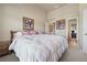 Bedroom with neutral colored walls and white bedding at 1829 Alcovy Shoals Blf, Lawrenceville, GA 30045