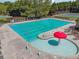 Community swimming pool and splash area surrounded by lounge chairs and lush greenery at 1829 Alcovy Shoals Blf, Lawrenceville, GA 30045