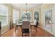 Charming breakfast nook with natural light, a glass table, and seating for four at 1829 Alcovy Shoals Blf, Lawrenceville, GA 30045