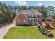 Charming brick home with green shutters, a front porch, and a beautifully landscaped yard at 1829 Alcovy Shoals Blf, Lawrenceville, GA 30045