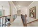 Upstairs hallway with wrought iron railing and carpeted floor at 1829 Alcovy Shoals Blf, Lawrenceville, GA 30045