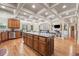 Open-concept kitchen with wood cabinets, a large center island, stainless steel appliances, and access to the living area at 1829 Alcovy Shoals Blf, Lawrenceville, GA 30045