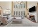 Spacious living room with a sectional sofa, fireplace, and large windows for natural light and views at 1829 Alcovy Shoals Blf, Lawrenceville, GA 30045