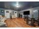 Inviting living room with wood floors, comfortable seating, and a large TV for entertainment at 1829 Alcovy Shoals Blf, Lawrenceville, GA 30045