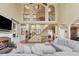 Cozy living room with a brick fireplace, built-in bookshelves, and an open view of the upper floor at 1829 Alcovy Shoals Blf, Lawrenceville, GA 30045