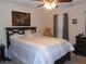 Comfortable bedroom with a large bed, ceiling fan, and window offering natural light at 2019 Briar Creek Ne Ct, Conyers, GA 30012