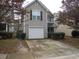 Charming two-story home featuring a one-car garage and a cozy front porch with stone accents at 2019 Briar Creek Ne Ct, Conyers, GA 30012