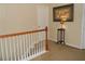 Upstairs hallway with carpet, wood railing, and art piece, blending functionality with style at 2019 Briar Creek Ne Ct, Conyers, GA 30012